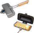 Non-stick sandwich pan open with a toasted sandwich inside